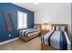 Stylish bedroom featuring twin beds, blue accent wall, and nautical decor at 2789 Southland St, St Cloud, FL 34772