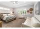Bright bedroom featuring a ceiling fan, window shutters, and a king size bed at 2789 Southland St, St Cloud, FL 34772