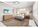 Bedroom features a king size bed, ceiling fan, and a dresser at 2789 Southland St, St Cloud, FL 34772