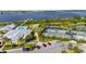 Aerial view of the community clubhouse, pool, tennis courts, and parking area near a lakefront setting at 2789 Southland St, St Cloud, FL 34772