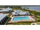 Overhead view of the pool area with lane lines, lounge chairs, umbrellas, and nearby clubhouse at 2789 Southland St, St Cloud, FL 34772