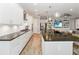 Modern kitchen features white cabinetry, stone countertops, and stainless steel appliances at 2789 Southland St, St Cloud, FL 34772