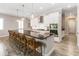 Modern kitchen featuring a large island with bar seating, stainless steel appliances, and sleek cabinetry at 2789 Southland St, St Cloud, FL 34772