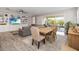 Open-concept living space with a dining area, modern decor, and sliding glass doors to the outdoor space at 2789 Southland St, St Cloud, FL 34772