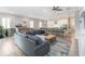 Stylish living area connecting to the kitchen, featuring an oversized sofa and modern decor at 2789 Southland St, St Cloud, FL 34772