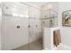 Luxurious walk-in shower with glass enclosure, tiled walls, and modern fixtures at 2789 Southland St, St Cloud, FL 34772
