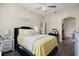 Bedroom featuring a comfortable bed, ensuite access, and ceiling fan at 2808 Osprey Cove Pl # 201, Kissimmee, FL 34746