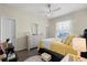 Bedroom featuring a comfortable bed, dresser, ceiling fan, and natural light at 2808 Osprey Cove Pl # 201, Kissimmee, FL 34746