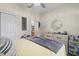 Bedroom featuring a comfortable bed, dresser, and ceiling fan at 2808 Osprey Cove Pl # 201, Kissimmee, FL 34746