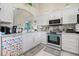 Bright kitchen featuring white cabinets, stainless steel appliances, and tile flooring at 2808 Osprey Cove Pl # 201, Kissimmee, FL 34746