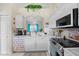 Bright kitchen featuring white cabinets, stainless steel appliances, and views to the backyard at 2808 Osprey Cove Pl # 201, Kissimmee, FL 34746