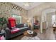 Cozy living room with a comfortable sofa, coffee table, and large mirror at 2808 Osprey Cove Pl # 201, Kissimmee, FL 34746