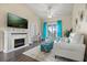 Bright living room features fireplace, vaulted ceilings, and access to outdoor space with beautiful blue accents at 2808 Osprey Cove Pl # 201, Kissimmee, FL 34746