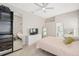 Bedroom with adjacent bathroom, soft lighting, neutral walls and carpet and television at 2884 Picadilly Cir, Kissimmee, FL 34747