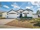 Well maintained home featuring a clean white exterior with nice landscaping at 2884 Picadilly Cir, Kissimmee, FL 34747
