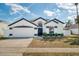 Charming single-story home featuring a two-car garage, complemented by a well-manicured lawn at 2884 Picadilly Cir, Kissimmee, FL 34747