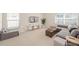 Comfortable living room with plush seating, neutral carpet, and plenty of natural light at 2884 Picadilly Cir, Kissimmee, FL 34747