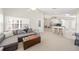 Bright living room features neutral carpet, modern furniture, and an open floor plan at 2884 Picadilly Cir, Kissimmee, FL 34747