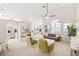 Spacious and bright living room with a ceiling fan and an open design leading to the dining and kitchen areas at 2884 Picadilly Cir, Kissimmee, FL 34747
