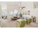 Bright living room features a ceiling fan, large windows, and comfortable seating with stylish decor at 2884 Picadilly Cir, Kissimmee, FL 34747