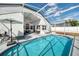 Sparkling pool with an enclosed patio, lounge chairs, and fan for those hot days at 2884 Picadilly Cir, Kissimmee, FL 34747