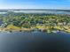 Stunning aerial view of lakefront home with lush landscaping and private dock access at 2926 Marquesas Ct, Windermere, FL 34786