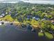 An aerial view showcasing the property with a private dock, pool, and lush greenery at 2926 Marquesas Ct, Windermere, FL 34786