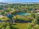 Stunning aerial perspective of a park with tennis court and covered picnic, set amidst lush greenery and waterfront scenery at 2926 Marquesas Ct, Windermere, FL 34786