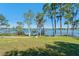 Picturesque backyard with mature trees and waterfront view, providing a private and tranquil outdoor space at 2926 Marquesas Ct, Windermere, FL 34786