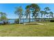 Expansive backyard with trees leading to a peaceful lake, offering serene waterfront living and natural beauty at 2926 Marquesas Ct, Windermere, FL 34786
