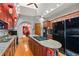 Well-lit kitchen with granite countertops, stainless steel appliances, and a central island cooktop at 2926 Marquesas Ct, Windermere, FL 34786