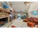 Spacious living room boasts a stone fireplace, high ceilings, and a view of the lake at 2926 Marquesas Ct, Windermere, FL 34786