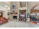 The cozy living room includes a stone fireplace, comfortable seating, and a view into the dining area at 2926 Marquesas Ct, Windermere, FL 34786