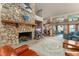 The expansive living room features stone fireplace, plush seating, and a view of the lake at 2926 Marquesas Ct, Windermere, FL 34786