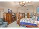 Large main bedroom with high ceilings, wood furnishings, ceiling fan, and ensuite entrances at 2926 Marquesas Ct, Windermere, FL 34786