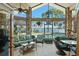The screened lanai features comfortable seating and a view of the lake and pool at 2926 Marquesas Ct, Windermere, FL 34786