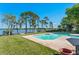 Backyard pool offers a refreshing escape with lake views and well-manicured lawn at 2926 Marquesas Ct, Windermere, FL 34786