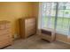 Bedroom featuring ample storage with multiple dressers and natural light from a window at 314 Casterton Cir, Davenport, FL 33897