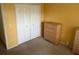 Bright bedroom with a double door closet, dresser and carpeted floor at 314 Casterton Cir, Davenport, FL 33897