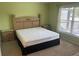 Bright bedroom featuring a wooden bed, plush carpet, and a window for natural light at 314 Casterton Cir, Davenport, FL 33897