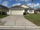 Charming single-story home with well-maintained lawn, and two car garage at 314 Casterton Cir, Davenport, FL 33897