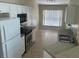 Well-lit kitchen featuring stainless steel appliances and ample counter space at 314 Casterton Cir, Davenport, FL 33897