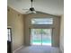 Bright living room with vaulted ceilings, ceiling fan, and view of a screened-in pool at 314 Casterton Cir, Davenport, FL 33897