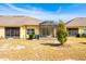 The backyard has a well-maintained lawn, mature tree, and exterior elevation with screened lanai at 3205 Sonesta Ct # F, Clermont, FL 34711