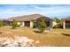 Expansive backyard view featuring a screened-in patio and well-manicured landscaping at 3205 Sonesta Ct # F, Clermont, FL 34711