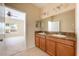 Bathroom featuring double sinks with granite countertops, and a doorway to the bedroom at 3205 Sonesta Ct # F, Clermont, FL 34711