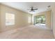 Bright bedroom with sliding glass doors to the patio and a ceiling fan at 3205 Sonesta Ct # F, Clermont, FL 34711