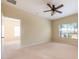 Bedroom with ceiling fan and window looking out onto a lush green lawn, offers a peaceful retreat at 3205 Sonesta Ct # F, Clermont, FL 34711