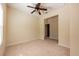 Bright bedroom with neutral carpet, ceiling fan, and open doorway, freshly painted and ready to move in at 3205 Sonesta Ct # F, Clermont, FL 34711