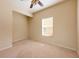 Comfortable bedroom with a ceiling fan and a window for natural light at 3205 Sonesta Ct # F, Clermont, FL 34711